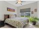 Serene bedroom featuring a comfortable bed, neutral decor, and a large window offering natural light and neighborhood views at 3970 Clipstone Pl, Sanford, FL 32773