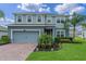 Beautiful two-story home with a lush green lawn and mature landscaping at 3970 Clipstone Pl, Sanford, FL 32773