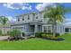 Charming two-story home featuring a two car garage, manicured lawn and colorful landscaping at 3970 Clipstone Pl, Sanford, FL 32773