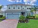 Inviting two-story home featuring a well-manicured lawn and a brick-paved driveway leading to a two-car garage at 3970 Clipstone Pl, Sanford, FL 32773