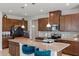 Bright kitchen boasting abundant cabinetry, granite countertops, stainless steel appliances, and bar seating at the island at 3970 Clipstone Pl, Sanford, FL 32773