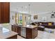 Modern kitchen seamlessly flowing into the living room, showcasing stainless steel appliances and a granite countertop island at 3970 Clipstone Pl, Sanford, FL 32773