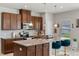 Well-equipped kitchen featuring granite countertops, stainless steel appliances, and stylish pendant lighting over the island at 3970 Clipstone Pl, Sanford, FL 32773