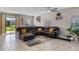 Spacious living room featuring tile floors, recessed lights, and a large sectional sofa for comfortable lounging at 3970 Clipstone Pl, Sanford, FL 32773