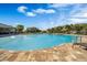 Community pool with brick pavers, lounge chairs, and lush landscaping, perfect for relaxation at 3970 Clipstone Pl, Sanford, FL 32773