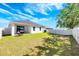 Well-maintained backyard with a grill, white fence, and lush green grass at 4231 Swan St, Haines City, FL 33844