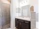The stylish bathroom features a tiled shower, modern vanity, and ample lighting at 4231 Swan St, Haines City, FL 33844