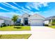Charming single-story home featuring a manicured front lawn and a two-car garage, creating inviting curb appeal at 4231 Swan St, Haines City, FL 33844