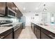 A modern eat-in kitchen with stainless steel appliances, granite countertops, and dark wood cabinetry at 4231 Swan St, Haines City, FL 33844