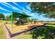 Community playground with shaded structures, slides, and swings for children to enjoy at 4231 Swan St, Haines City, FL 33844