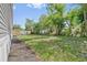 Spacious backyard offering ample space for outdoor activities, bordered by mature trees at 4425 Mobilaire Dr, Orlando, FL 32822