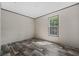 Well-lit bedroom boasts wood-look floors, neutral walls and a large window at 4425 Mobilaire Dr, Orlando, FL 32822