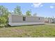Cozy grey one story home with a well-maintained side yard at 4425 Mobilaire Dr, Orlando, FL 32822