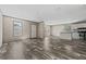 Open-concept living space boasts wood-look floors, natural light, and kitchen with stainless steel appliances at 4425 Mobilaire Dr, Orlando, FL 32822