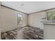 Bright living area features modern wood-look floors, neutral walls and a charming kitchenette at 4425 Mobilaire Dr, Orlando, FL 32822