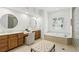 Bright bathroom with double vanity, soaking tub, and plantation shutters at 4517 Old Carriage Trail, Oviedo, FL 32765