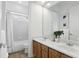 Bright bathroom with double sinks, neutral walls, and a shower over tub at 4517 Old Carriage Trail, Oviedo, FL 32765