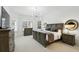 Large main bedroom with plenty of natural light and decorative light fixture at 4517 Old Carriage Trail, Oviedo, FL 32765