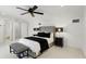 Bedroom with a ceiling fan, an upholstered headboard, and neutral walls at 4517 Old Carriage Trail, Oviedo, FL 32765