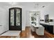 Elegant dining room with hardwood floors, stylish lighting, a marble-topped dining table, and sophisticated decor at 4517 Old Carriage Trail, Oviedo, FL 32765