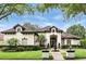 Stunning single-story home with a tile roof, manicured lawn, beautiful landscaping, and a front fountain at 4517 Old Carriage Trail, Oviedo, FL 32765