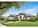 Beautiful single-story home featuring a tile roof, well-kept lawn, mature landscaping, and a serene front fountain at 4517 Old Carriage Trail, Oviedo, FL 32765