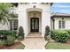 Close-up showcasing the elegant arched entryway and ornate wrought iron front door of a beautiful home at 4517 Old Carriage Trail, Oviedo, FL 32765