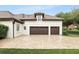 Spacious two-car garage with dark wood doors and a brick paver driveway, offering ample parking at 4517 Old Carriage Trail, Oviedo, FL 32765