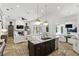 Spacious kitchen featuring stone countertops and an island that opens to the living room at 4517 Old Carriage Trail, Oviedo, FL 32765