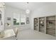 Bright office features built-in bookcases, modern light fixture, and a window at 4517 Old Carriage Trail, Oviedo, FL 32765