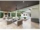 Outdoor covered patio featuring a stone fireplace and comfortable seating, overlooking a pool and lush backyard at 4517 Old Carriage Trail, Oviedo, FL 32765