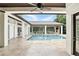 Covered outdoor pool area features tile flooring, and an outdoor seating area at 4517 Old Carriage Trail, Oviedo, FL 32765