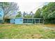Backyard featuring an enclosed porch area and mature trees at 510 Brighton Way, Casselberry, FL 32707