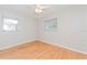 Well-lit bedroom with wood-look flooring and dual windows at 510 Brighton Way, Casselberry, FL 32707