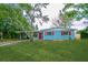 Charming single story home with a lush green lawn, red shutters and door and mature landscaping at 510 Brighton Way, Casselberry, FL 32707