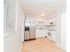 Bright, white kitchen featuring stainless steel refrigerator and white appliances at 510 Brighton Way, Casselberry, FL 32707