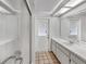 Bathroom with a walk-in shower, vanity with storage, and a door leading to the outside at 5212 Waterwood Run, Bartow, FL 33830