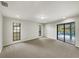 Bright bedroom with neutral carpet, windows, and sliding door at 5212 Waterwood Run, Bartow, FL 33830