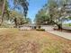 Charming single-story home featuring mature trees, a well-maintained lawn, and an attached two-car garage at 5212 Waterwood Run, Bartow, FL 33830