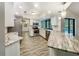 Bright kitchen with stainless steel appliances, white cabinets, and granite countertops at 5212 Waterwood Run, Bartow, FL 33830
