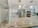 Modern kitchen featuring stainless steel appliances, granite countertops, and wooden-look floors at 5212 Waterwood Run, Bartow, FL 33830