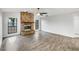 Bright living room featuring a brick fireplace, wood floors, and natural light from two windows at 5212 Waterwood Run, Bartow, FL 33830