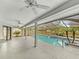 This is a view of the screened-in in-ground pool and patio area with ceiling fans at 5212 Waterwood Run, Bartow, FL 33830