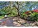 Backyard sitting area with a waterfall feature and lush landscaping, perfect for relaxation at 5301 Forest Breeze Ct, St Cloud, FL 34771