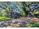 The backyard is adorned with mature trees, lush landscaping, pool area and a spacious lawn at 5301 Forest Breeze Ct, St Cloud, FL 34771