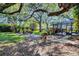 Expansive backyard featuring lush landscaping, mature trees, screened-in pool and a fire pit at 5301 Forest Breeze Ct, St Cloud, FL 34771