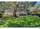 Sprawling backyard with mature trees, lush landscaping, pool area, and extensive lawn at 5301 Forest Breeze Ct, St Cloud, FL 34771