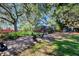 A spacious backyard featuring a pool, lush lawn, mature trees, and a variety of foliage at 5301 Forest Breeze Ct, St Cloud, FL 34771