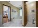 Bathroom featuring a garden tub, white cabinets, and tiled floors with a view into the bedroom at 5301 Forest Breeze Ct, St Cloud, FL 34771