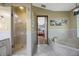 Bathroom featuring a tiled garden tub, glass enclosed shower and travertine tile floors at 5301 Forest Breeze Ct, St Cloud, FL 34771